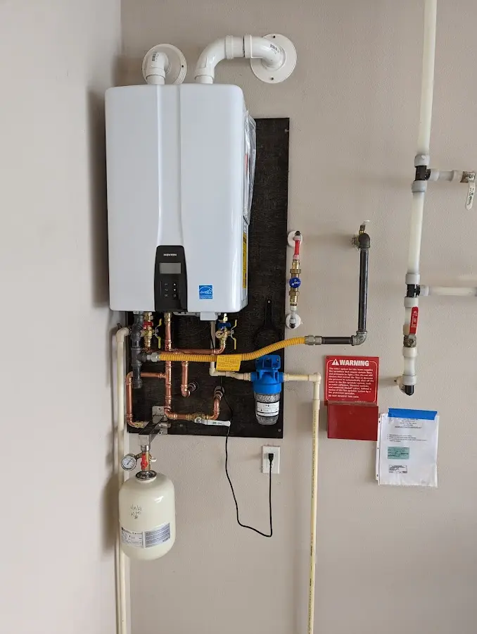 Professional plumber installing copper piping in a Midvale home